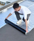 Pro Grade Self Adhesive Roofing Felt And Leak Proof Flashing Tape With Reflective Aluminum Foil being rolled out on a rooftop.