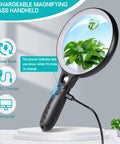 Ultra Bright Handheld Magnifier With 37 LED Lights showing a plant through a 5.2-inch lit optical lens, USB charging cable attached