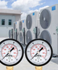 Front close-up of two Winters 2-inch pressure gauges with brass internals, black steel cases, psi/kPa, 1/4 in. NPT.