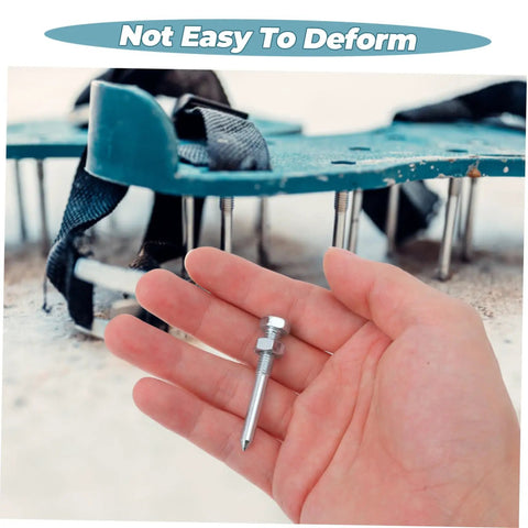 Close-up of hand holding metal peg from 20 Pcs Lawn Aerator Shoe Spikes For Grass Aeration, with aerator shoe in background