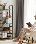 Five Tier Tall Bookshelf Corner Organizer In Brown That Keeps Your Garage Kit CDs Movies And More Neatly Stacked next to a woman reading