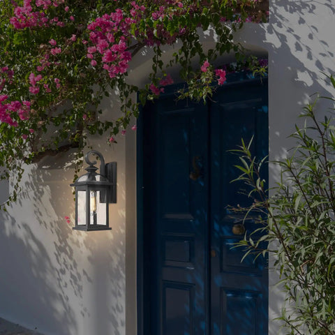 Outdoor Wall Light Sconce With Seeded Glass Weatherproof Aluminum Exterior Fixture mounted beside blue door on white wall