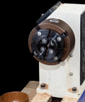 SIIIXS 4-inch wood lathe chuck, 4-jaw self-centering with adapters, mounted on a white bench lathe