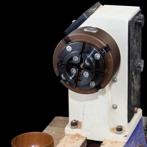 SIIIXS 4-inch wood lathe chuck, 4-jaw self-centering with adapters, mounted on a white bench lathe