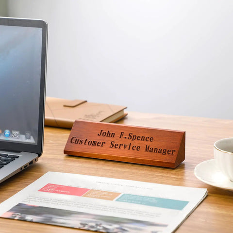 Two Pack Blank Wood Name Plates For Desk In Walnut Finish displayed on wooden desk near laptop, customizable for offices.