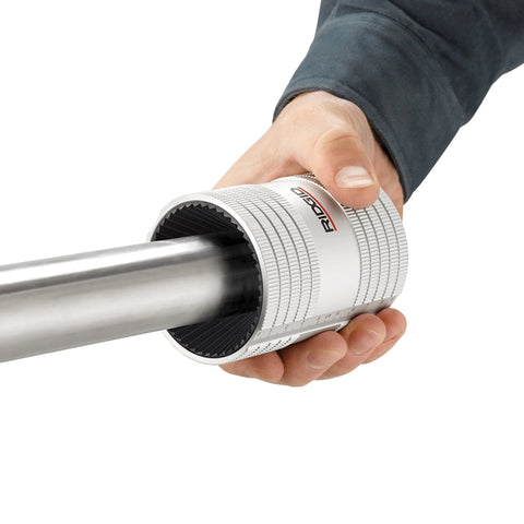 Ridgid stainless steel pipe reamer tool with chrome finish, 1/2–2 in range, held in hand (side view)