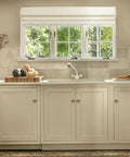 Antique Brass Cabinet Knobs 25 Pack With Screws 1.2 Inch Round Cabinet Door Knobs installed on white kitchen cabinets