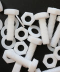 Top Shelf Natural PTFE Hex Head Bolts With Matching Nuts And Washers M6 X 20mm on a dark background, showing plastic fasteners.