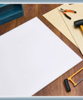 HDPE sheet, white, 1/2 in thick, 24 in by 48 in, flat on wood workbench with tools nearby