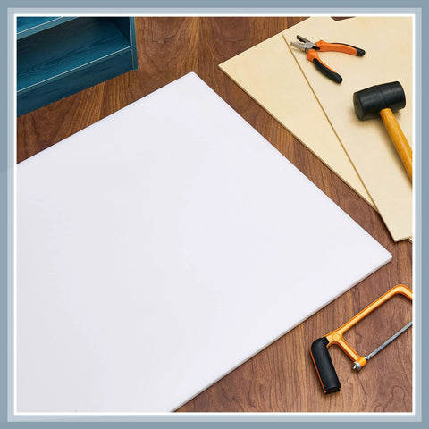 HDPE sheet, white, 1/2 in thick, 24 in by 48 in, flat on wood workbench with tools nearby
