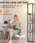 Floor Lamp With Shelves And LED USB Type C Ports Built In AC Outlet Three Color Temperatures Storage Display Walnut Wood Column Tall Standing Lamp For Living Room Bedroom Or Office beside a woman reading on a sofa in a cozy room.