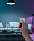 Person using One Tap Smart Remote For Your Home Automation Needs Works With Curtain Bot Color Bulb LED Strip Blind Tilt And Plug Mini Bluetooth Five Point Zero Long Range Easy Control No Phone Required in modern living room.