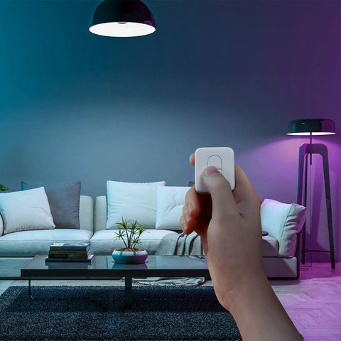 Person using One Tap Smart Remote For Your Home Automation Needs Works With Curtain Bot Color Bulb LED Strip Blind Tilt And Plug Mini Bluetooth Five Point Zero Long Range Easy Control No Phone Required in modern living room.