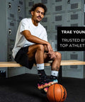 Basketball player sitting on bench in locker room with basketball, promoting trust by top athletes.