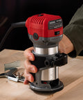 Using Compact Wood Router Tool With 6.5 Amp 1.25 HP Motor, 13000-33000 RPM on wooden surface for precise edging