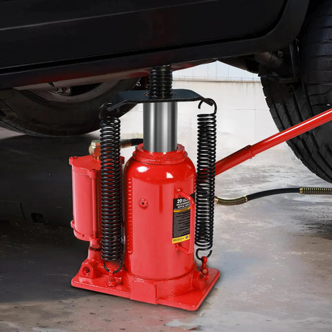 Close-up of Big Red 20 Ton Air Hydraulic Bottle Jack Heavy Duty Professional Lifting Tool in use under a vehicle.