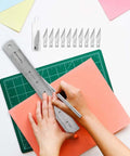 28-piece precision craft tools set for vinyl weeding; metal ruler, scalpel blades, blade case on green cutting mat.