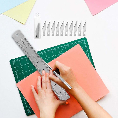 28-piece precision craft tools set for vinyl weeding; metal ruler, scalpel blades, blade case on green cutting mat.