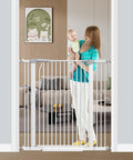 Extra Wide Baby Gate With Walk Through Door, Adjustable 25 To 80 Inch Openings, shown in a doorway with toddler and parent