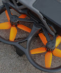 Close-up of Avata Drone Propellers Replacement Set Orange 8 Pack With Screws for FPV Quadcopter installed on a drone.