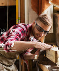 Heavy Duty Clear Safety Glasses For Guys Ansi Z87.1 Polycarbonate Eye Shields Scratch Proof Wind Dust Guard Built Tough For Indoor Outdoor Job Sites 30 Pack on a man working on wood.
