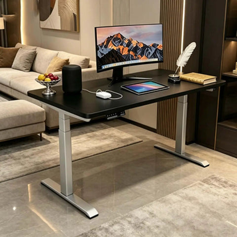 Rock Solid Dual Motor Electric Standing Desk With Smooth Height Adjustable Sit And Swap Frame Built Tough, matte black top with monitor and decor.