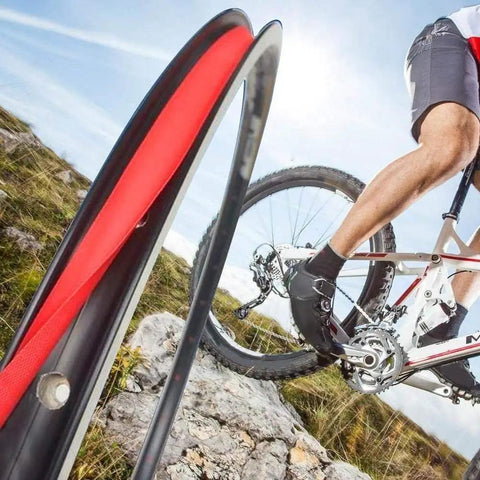 Cyclist on rocky terrain with Rim Tape Set For Road And Mountain Bikes, 700C Fit, 18-20mm Tire Rim Strips, Durable PVC Rim Liner, 10 Pieces.