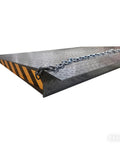 Hardcore 59X79 Heavy Duty Dock Board And Container Ramp Built Like A Tank For 13228 Lb Loads showing diamond grip surface and safety chain.