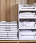 Four Pack Foldable Wardrobe Storage Boxes stacked in closet, showing collapsible Plastic Closet Organizer Baskets with folded clothes.