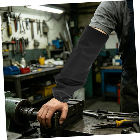 Legit Flame Resistant Welding Sleeves And Built Different Cotton Arm Guards Offering Heavy Duty Heat Protection For Serious Shop Work And Mechanic Hustles with a hand resting on a metal workbench.
