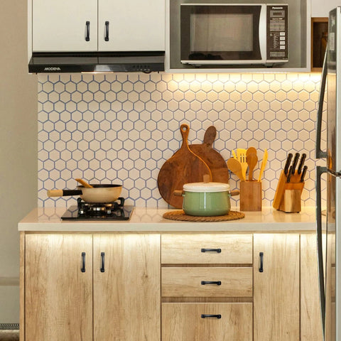 Modern kitchen with Arch Cabinet Pulls 3 Inch Matte Black Solid Zinc Die Cast on wooden cabinets, featuring cookware and utensils.