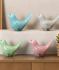 Heckin Cute Green Bird Toilet Bolt Covers Pair Decorative Ceramic Screw Caps For Bathroom Fixtures Zero Hassle Easy Install Dope Hardware Swag Straight Up Stylish Restroom Upgrade Today. Four colorful ceramic bird figurines with floral designs.