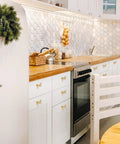 Gold Bow Drawer Knobs Set 16 Pcs Brass Bow Handles for Dresser and Cabinets in a modern kitchen setting