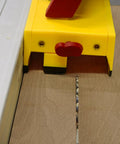 GrabberPRO LITE Push Block for Table Saws and Router Tables with adjustable leg in use on wooden surface, yellow color