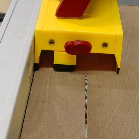 GrabberPRO LITE Push Block for Table Saws and Router Tables with adjustable leg in use on wooden surface, yellow color