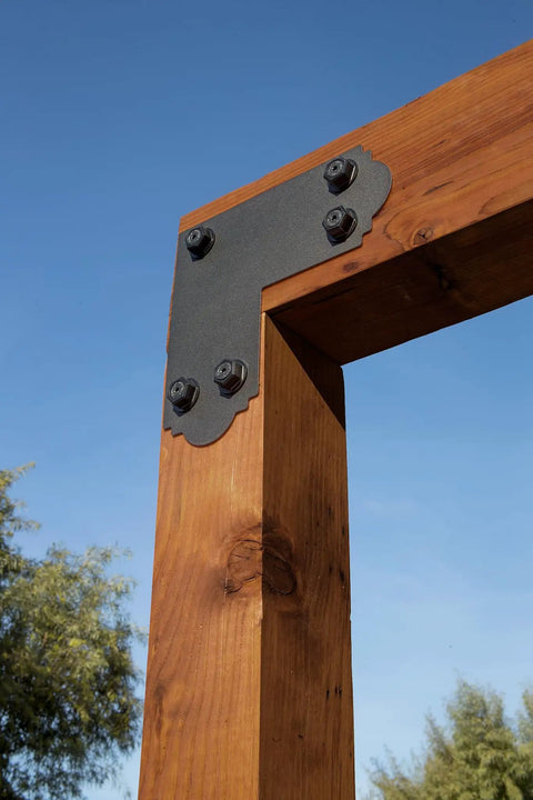 Mission Collection ZMAX Black Powder Coated L Strap For 6x6 Posts 12 Gauge Steel Outdoor Accents attached to wooden frame outdoors