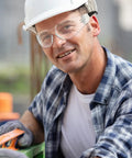 Top Shelf Tinted Safety Glasses Bulk Pack Includes 50 Pieces For Men And Women With Ansi Z87.1 Certification worn by a worker.