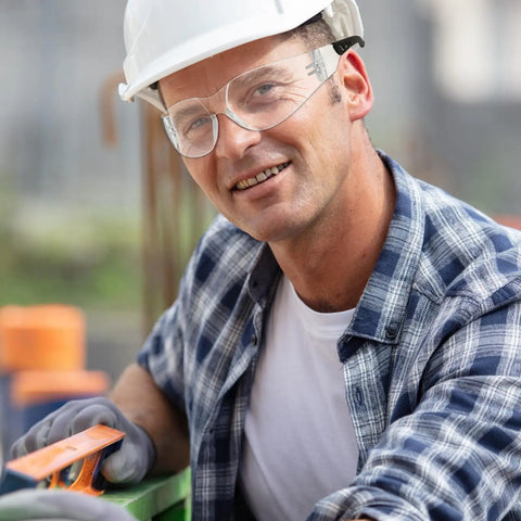 Top Shelf Tinted Safety Glasses Bulk Pack Includes 50 Pieces For Men And Women With Ansi Z87.1 Certification worn by a worker.