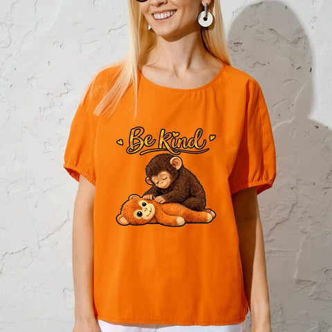 Cute Babys Monkey Punchs Team DTF Transfers 7x7 Inches on orange shirt with cartoon design and 'Be Kind' text