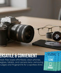 Ultra Clarity lens cleaning wipes 210-pack in blue packets on a desk beside a camera, glasses, and smartphone.