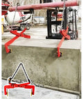 Built Like A Tank Heavy Duty Stone Lifting Clamps lifting a concrete slab with chains and hooks in a construction site setting.
