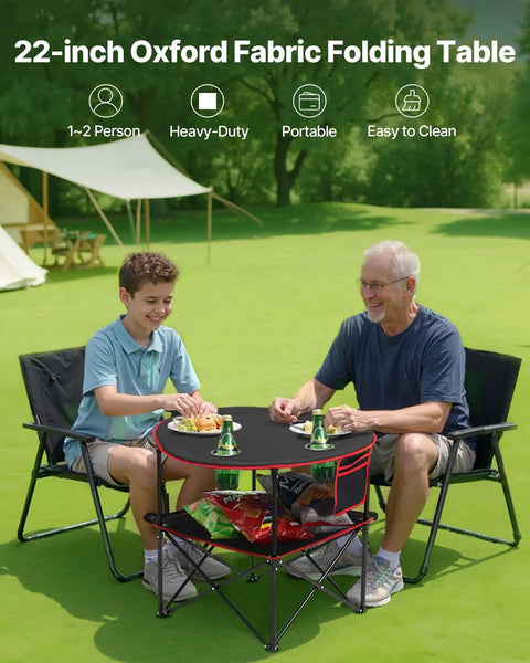 Folding Camping Table For Outdoor Adventures Portable Lightweight Picnic Table With 66 Lb Capacity Waterproof 600D Oxford Fabric Four Cup Holders Carry Bag Tailgating Camping Beach Trips, featuring two people sitting and dining outdoors.