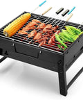 Portable Folding Charcoal Grill For Outdoor BBQ On The Go Stainless Steel Tabletop Smoker with food grilling on skewers.