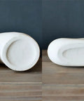 Underside view of the Donut Vase Set Of 2 White Ceramic Vases Large Nordic Minimalist Hollow Centerpieces for stability check.
