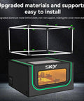 Laser engraver enclosure front view with LED light and vent kit; black housing with green trim, SKY logo