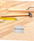 Heavy Duty Adjustable Self Closing Stainless Steel Door Hinges For High Humidity Environments In Kitchens And Bathrooms With Precision Design For Smooth Operation And Elegant Aesthetic next to hammer and tape measure on wooden surface