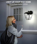 Woman approaching house with Dope Dusk To Dawn Outdoor LED A19 Light Bulbs 5000K Daylight White 13W illuminating porch