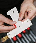 Hands holding Portable Car Spot Welder And Sheet Metal Repair Torch for Auto Body Fixes, close-up of white welder tool