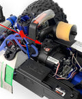Close-up of a Traxxas E-Revo 2.0 RC car chassis with Sturdy Steel 48T M1 Spur Gear Set For One Tenth Scale RC Cars Upgrade Fits Traxxas Arrma Losi HPI Savage Hobao Revo Two Point Zero Includes Seven Gear Teeth For More Gear Ratios Smoother Power And Tougher Durability installed