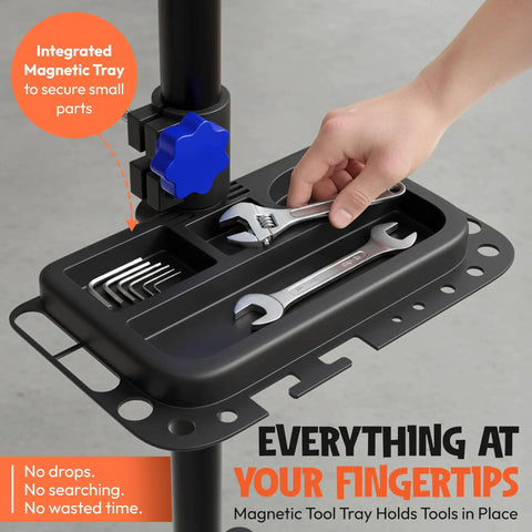 Hand placing wrench on magnetic tool tray of Bike Repair Stand With Workstand Mat And Detachable Wall Mount Clamp Ebike Floor Holder.